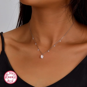 Detail of 925 sterling silver necklace with square cubic zirconia on a female model