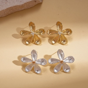 Minimalist metallic flower stud earrings in gold and silver finish with brushed texture