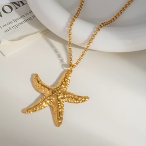 Gold starfish pendant necklace with hammered texture on a minimalist O-shaped chain