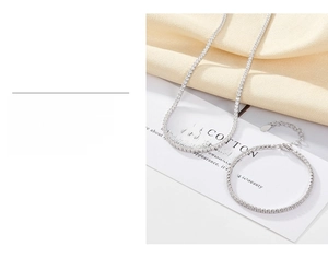 Detail of silver tennis necklace and bracelet with triple-layer gold plating and zircons