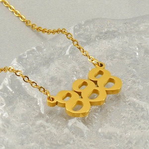 Golden stainless steel necklace featuring 888 number pendant on textured glass