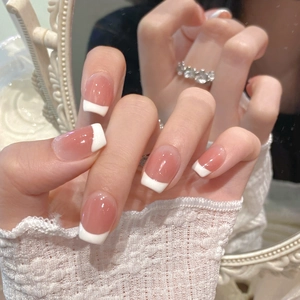 Classic french nude pink gradient press-on nails with white tips on oval shape