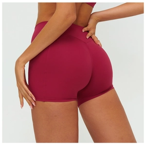 Macro shot of high-waist scrunch butt yoga shorts in burgundy with flatlock seam details