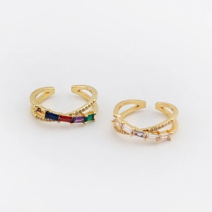 Detail of two-layer gold rings with colorful rainbow and clear zircon rectangular stones
