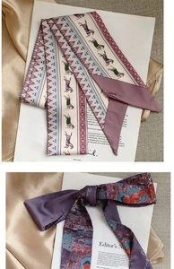 Detailed view of elegant twilly scarves with vintage horse and oriental artistic patterns