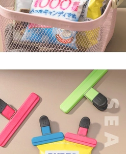 Macro detail of multi-color plastic food bag sealing clips with rubber grips for kitchen use