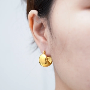 Minimalistische dicke goldene Tropfen-Creolen aus Edelstahl getragen am Model