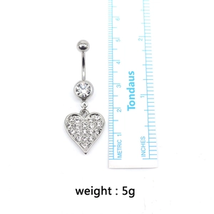 Detailed scale measurement of heart-shaped zircon belly ring showing size and 5g weight