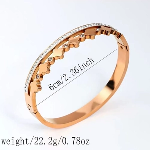 Rose gold stainless steel four leaf clover bangle with zircon stones and polished finish