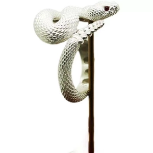 Adjustable rattlesnake silver ring with detailed scales and ruby red gemstone eyes