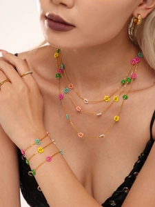 Detail of colorful handmade flower beaded necklace and bracelet set on a model