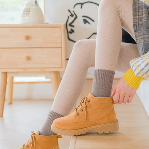 Thick warm mid-calf wool socks for women paired with stylish camel suede ankle boots