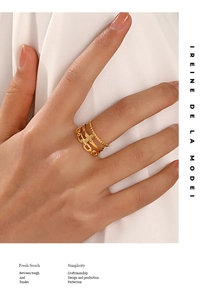 Close-up of three-layer 18K gold-plated chain ring set with elegant cross detail