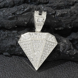 Macro shot of silver diamond-shaped hip-hop pendant encrusted with clear crystals