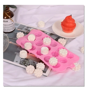 Detailed view of 15-cavity pink silicone mold with 3D floral shapes for DIY crafts