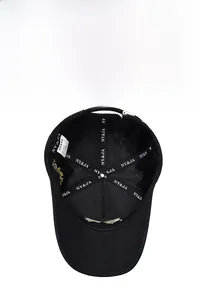 Detail view of the baseball cap's inner lining with logo tape and adjustable metal buckle