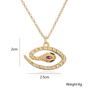 Detail view of gold-plated snake pendant with white zircons and purple stone eye