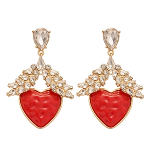 Vintage gold heart earrings with red resin and sparkling rhinestones on white background