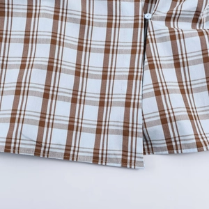 Brown and white checkered poplin shirt with a white round button and neat stitching details