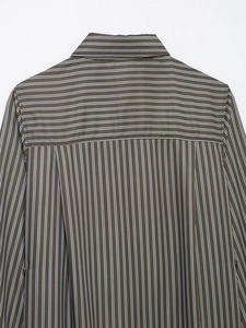 Detail of vertical and horizontal stripes on the back yoke of a brown poplin shirt