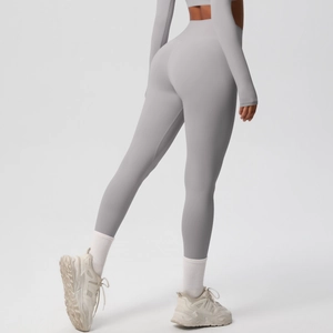 Detail of high-waisted gray yoga pants showing seamless compression fabric and body contouring