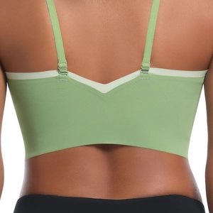 Detail of light green sports bra featuring adjustable thin straps and V-shaped back design