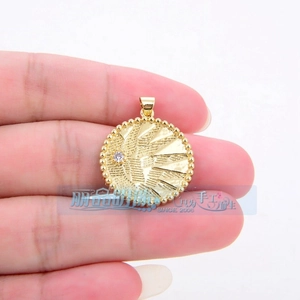 Detailed macro view of a golden circular pendant with radial texture and micro-inlaid zircon