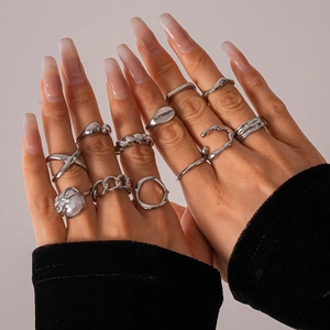 Detailed view of silver minimalist geometric rings styled in a layered stack on fingers