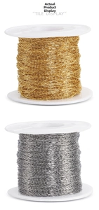 Detail of fine gold and silver stainless steel cable chains on white plastic spools