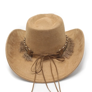 Close-up of brown suede cowboy hat with fringe tassel and metallic charm accents