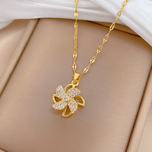 Detailed close-up of a rotating windmill necklace with sparkling white zircons in a gift box