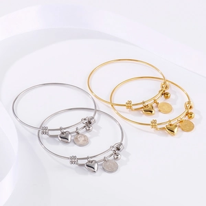 Set of 4 adjustable stainless steel bangles with gold and silver heart coin charms