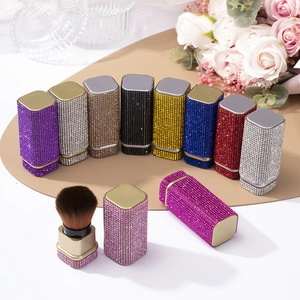 Detail view of luxurious rhinestone-encrusted makeup brush for powder and foundation.