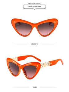 Detail of orange heart-shaped sunglasses featuring gold interlocking D-logo on temple