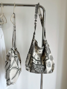 Detailed macro view of vintage paisley and geometric printed linen shoulder tote bags