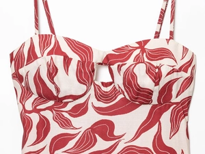 Detailed view of red and white floral midi dress with spaghetti straps and chest cutout