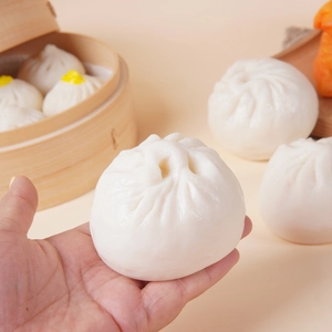 Realistic PVC steamed bun model toy held by hand with wooden steamer display