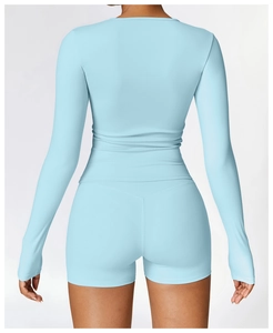 Rear view of light blue long-sleeve yoga set showing ergonomic seams and back contour
