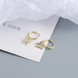 Detailed view of gold butterfly hoop earrings with sparkling cubic zirconia stones