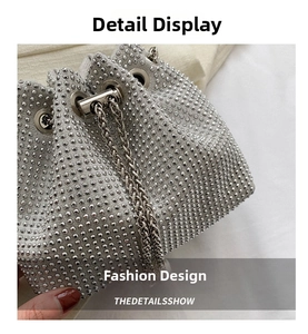 Close-up of sparkling silver rhinestones and metal chain on a drawstring bucket bag