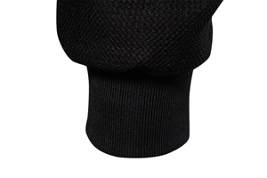 Close-up of black men's jacket showing honeycomb knit texture and ribbed cuff detail