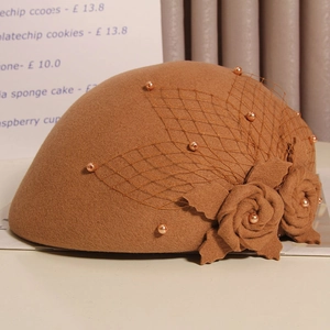 Detail of wool beret with coffee mesh veil, faux pearls and handmade felt flowers