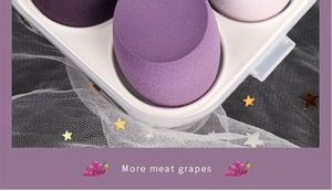 Detail of four purple soft makeup sponges in a storage box with grape design