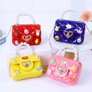 Mini jelly handbags for kids with pearl handles and cute cartoon charms in four colors