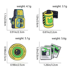 Detailed size guide for vintage camera and film roll enamel pins with dimensions and weight