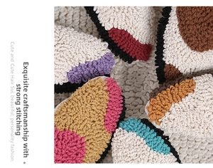 Detail of tufted geometric patterns showing soft looped texture and secure stitching