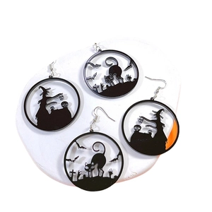 Halloween acrylic drop earrings with black cat and witch silhouettes on white stone stand