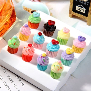 Miniature colorful resin cupcakes set with heart decorations on a white display stand