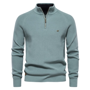 Detailed close-up of light blue men's half-zip knit sweater showing premium ribbed texture