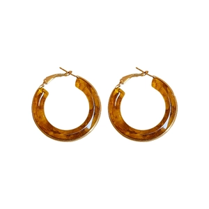 Retro amber resin hoop earrings with golden metal clasps on a white background